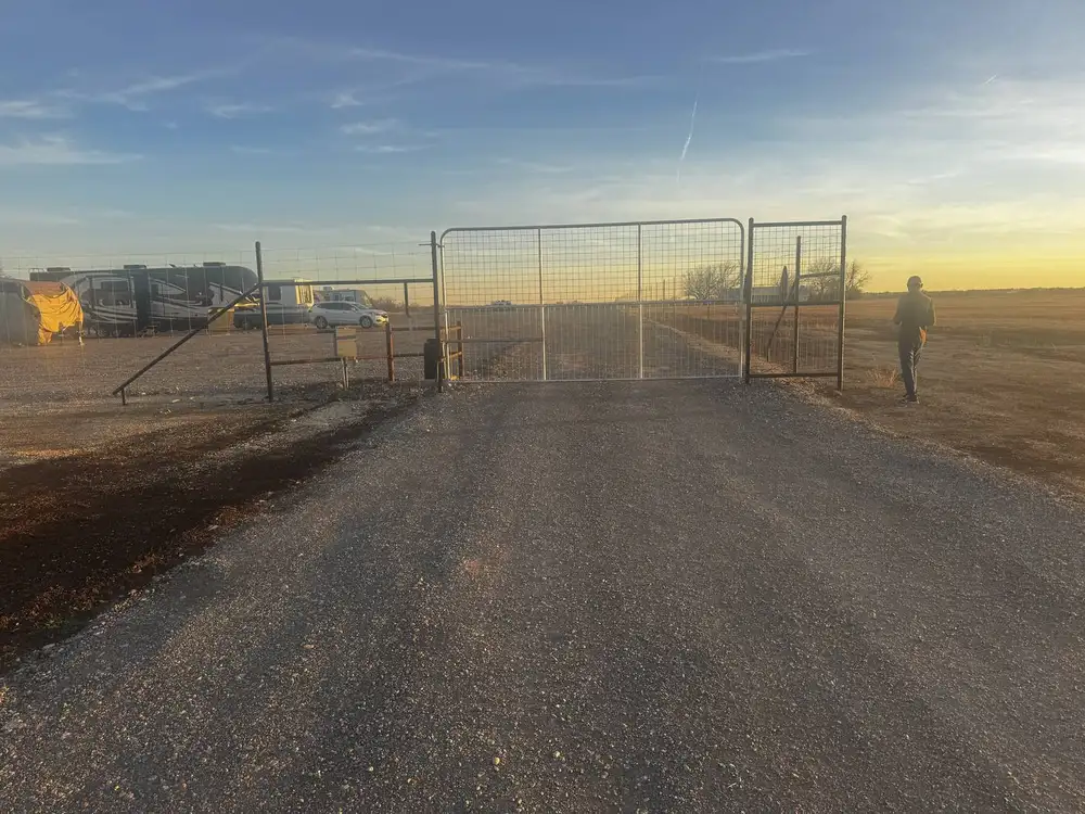Automatic drive-through gate at Dziuks Truck Parking at sunset