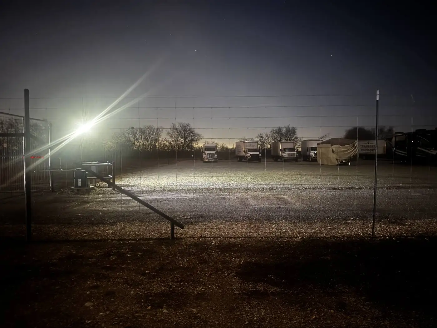 Dziuks Truck Parking fully lit at night with trucks inside